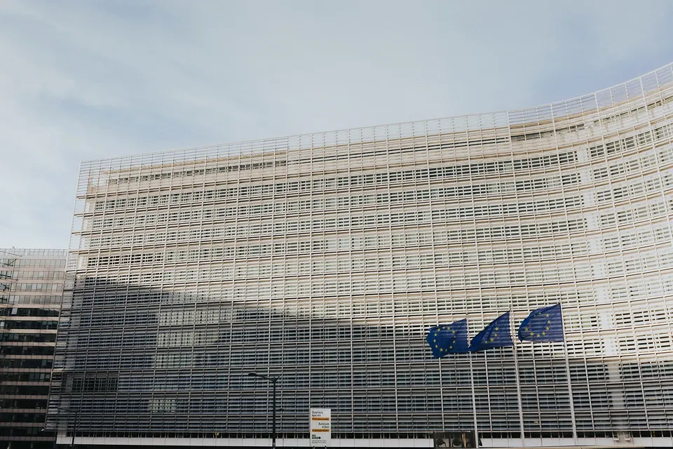 The Berlaymont building in Brussels with the European Union flag in front